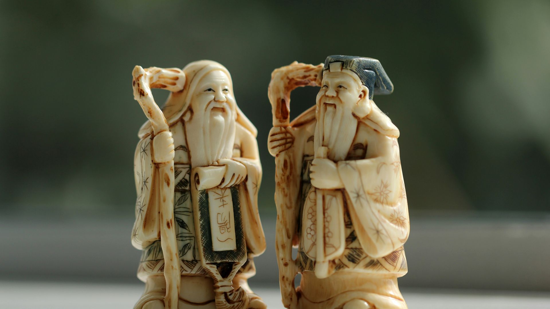 person taking photo of ceramic figurines on table