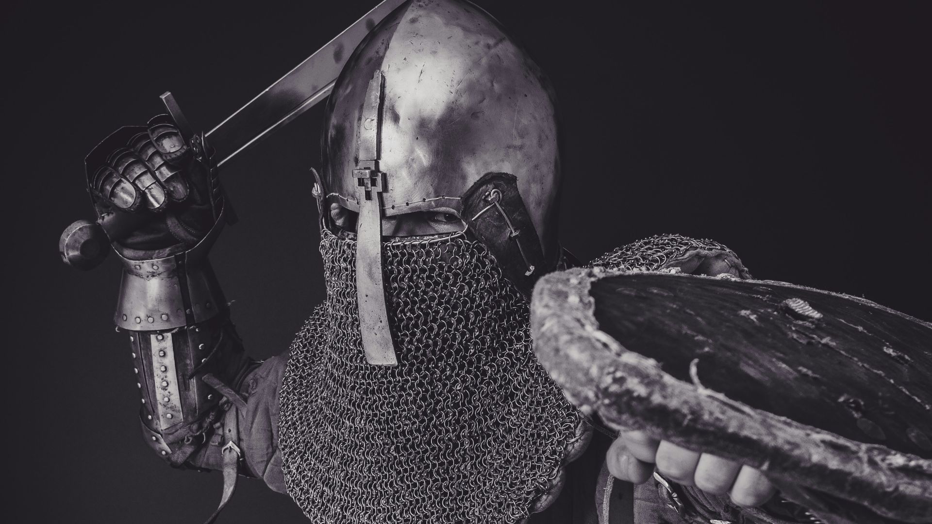 man with steel and chainmail armor holding sword