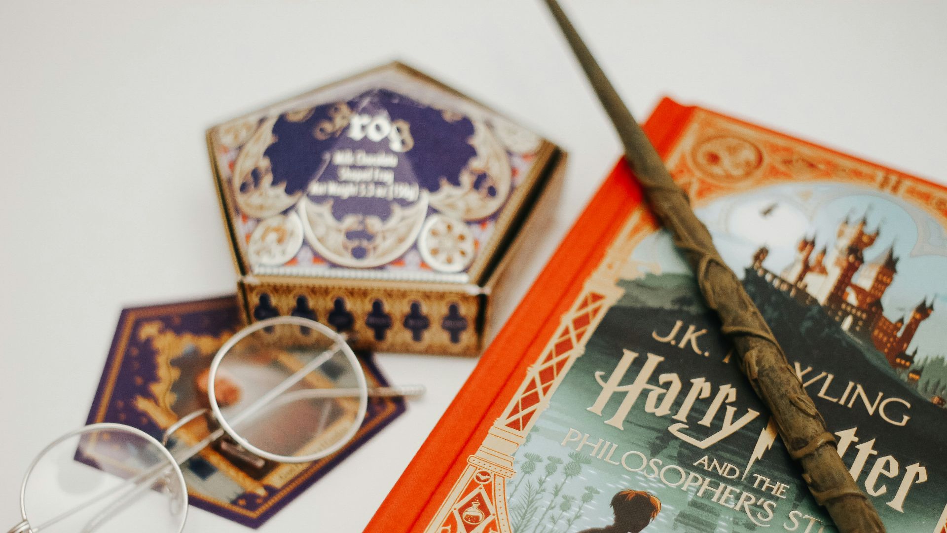 gold framed eyeglasses on red book