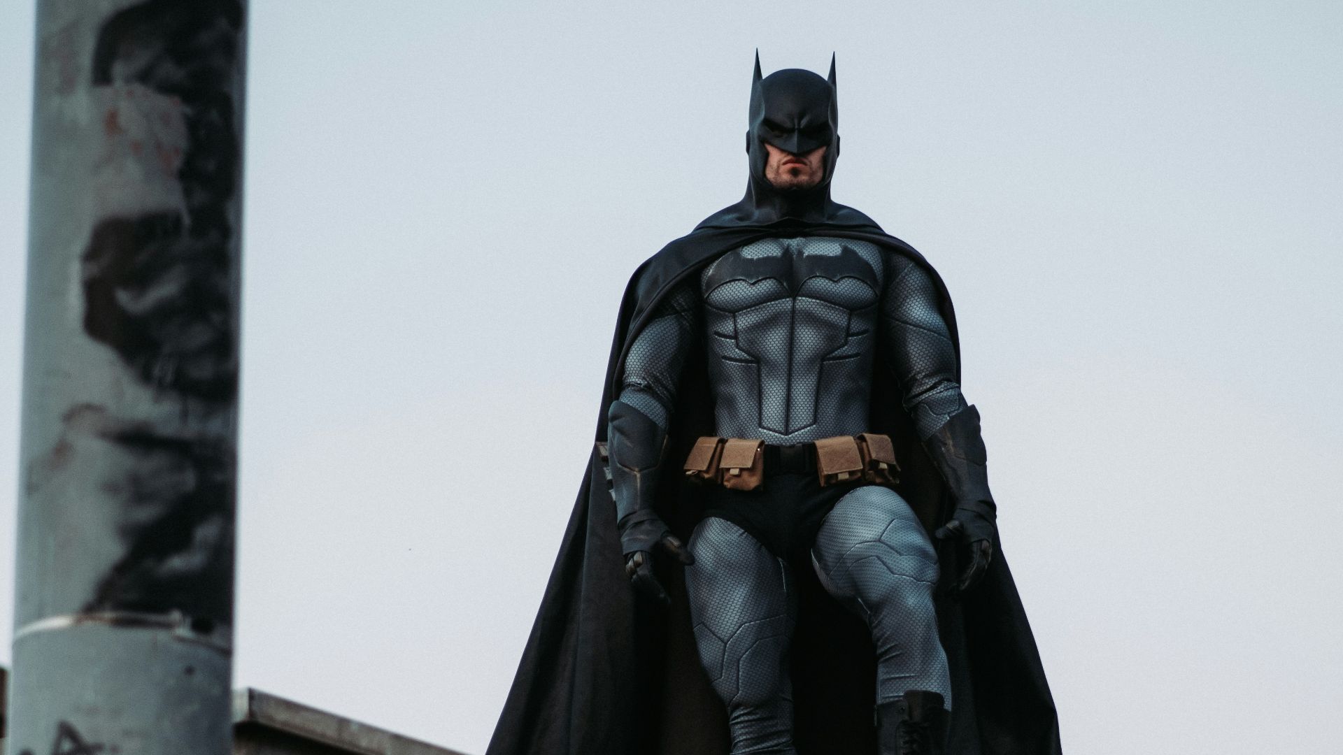 man in black jacket and pants standing on roof