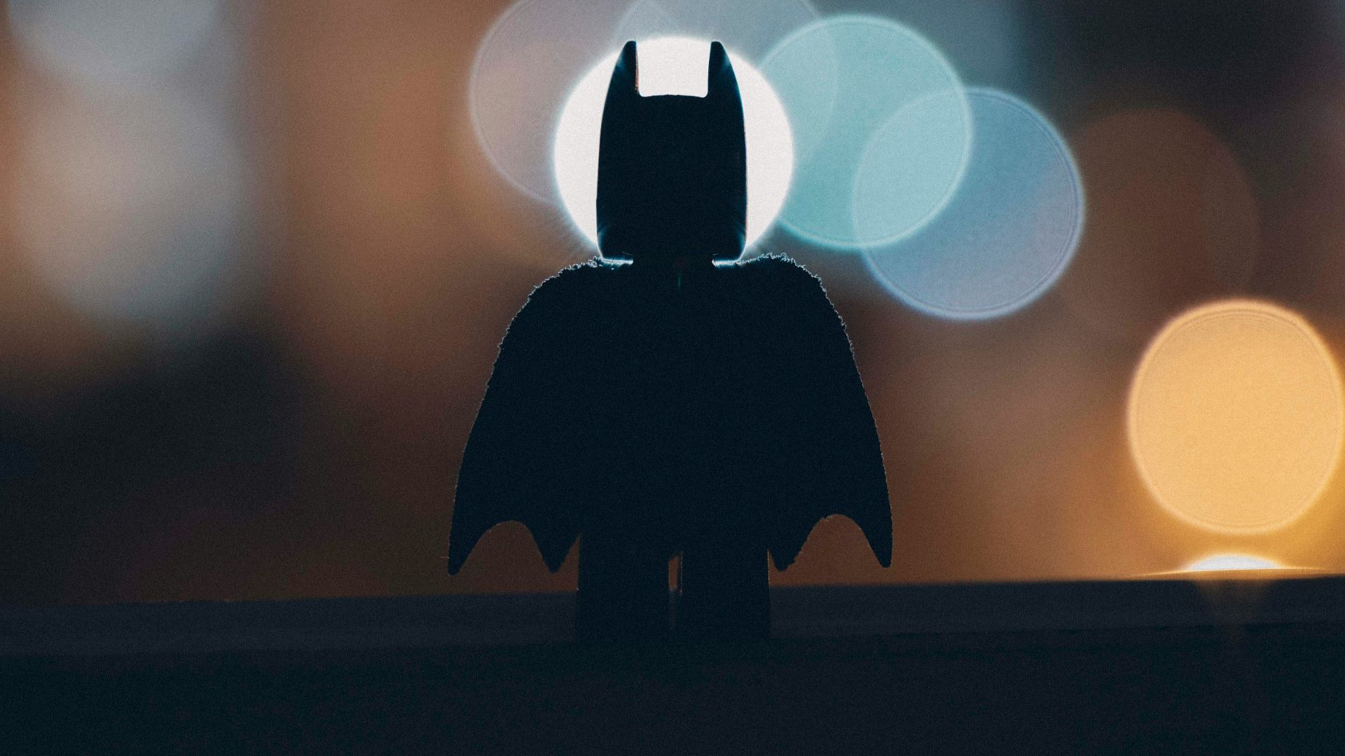 silhouette of person standing on the road during night time