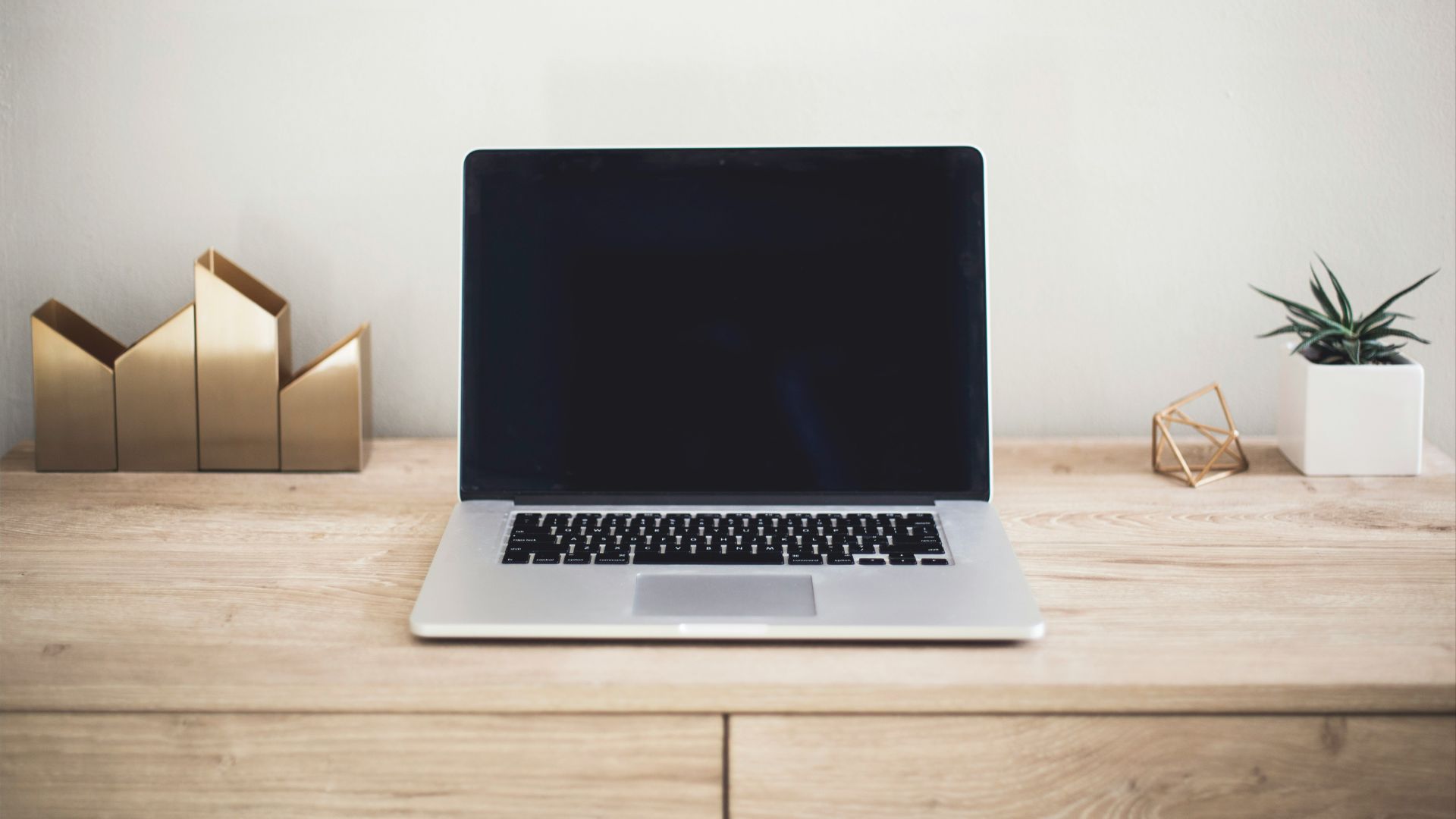 MacBook Pro on top of brown table
