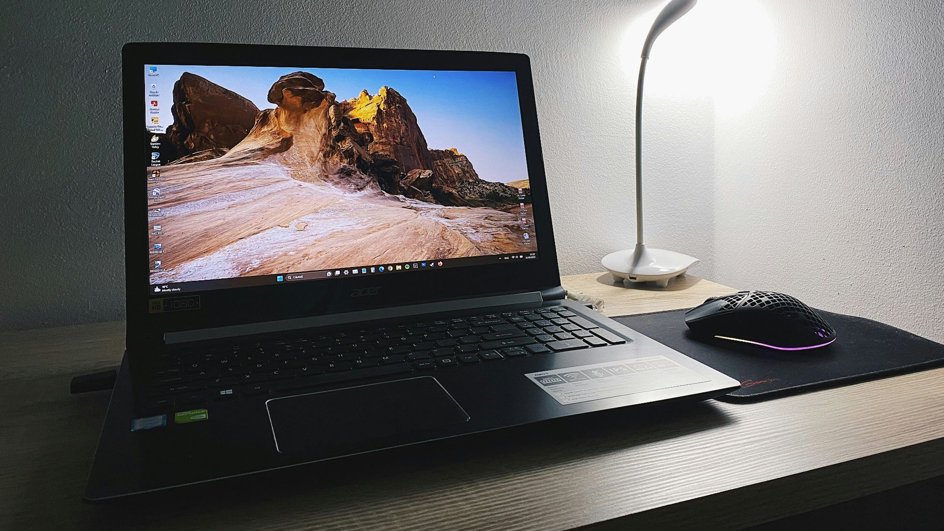 a laptop computer sitting on top of a wooden desk