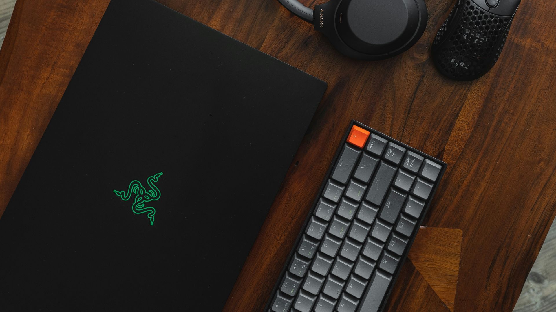 black laptop computer beside black and silver headphones