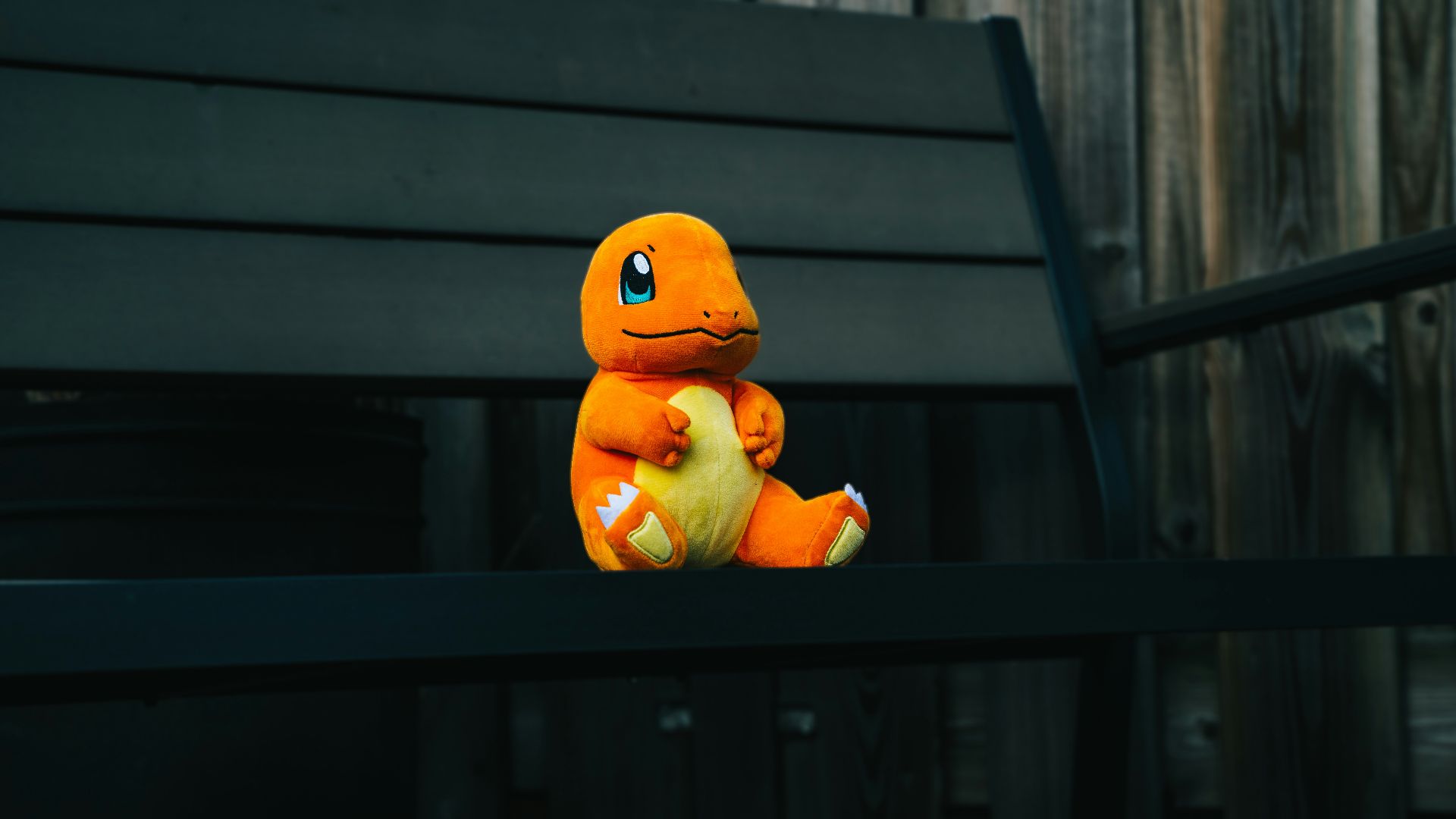 a stuffed toy sitting on top of a wooden bench