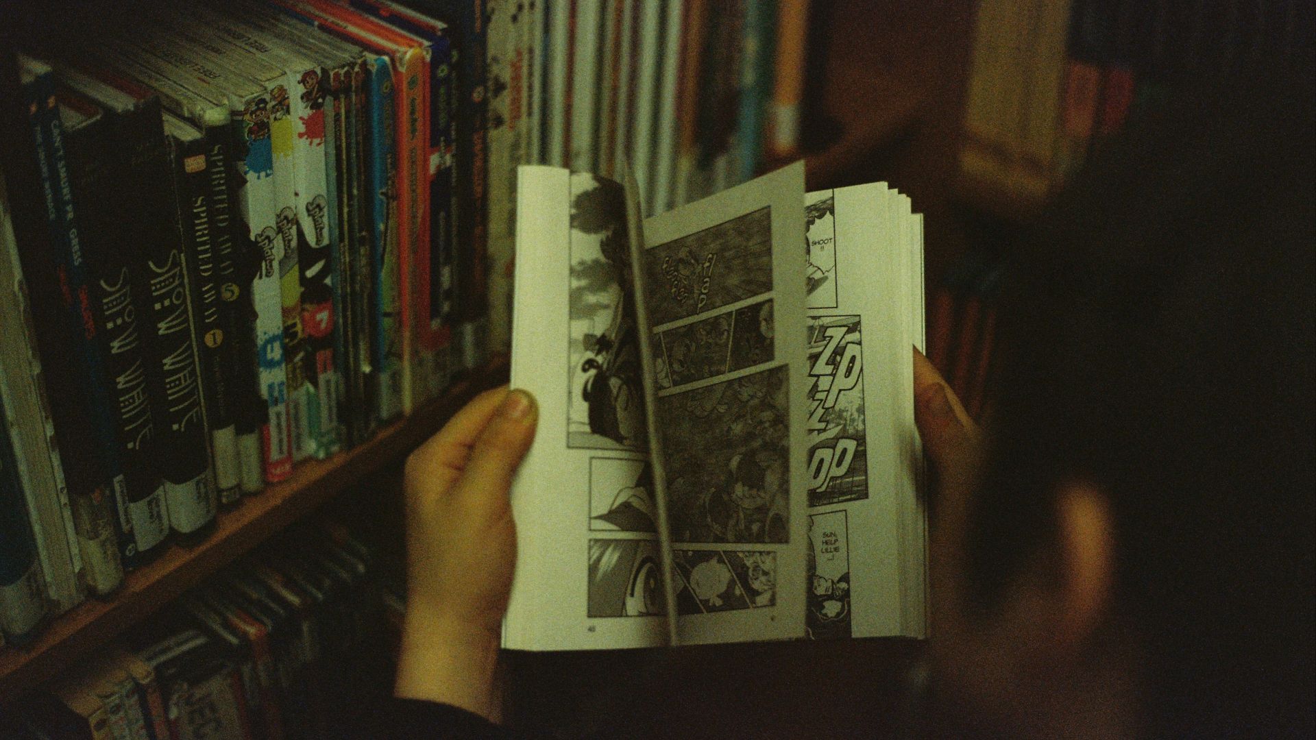 person holding white and black book