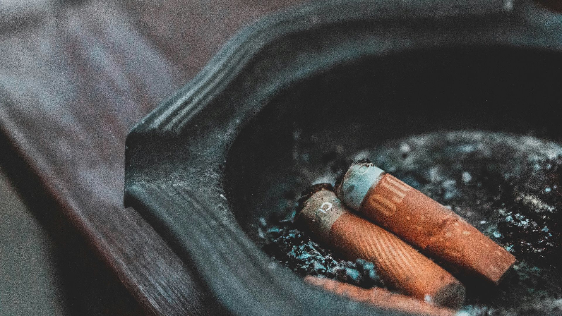 three cigarette butts on ashtray