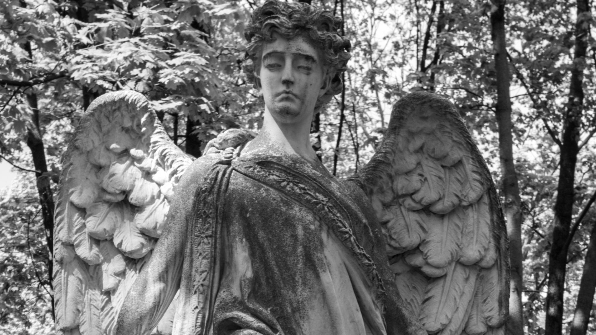a black and white photo of an angel statue
