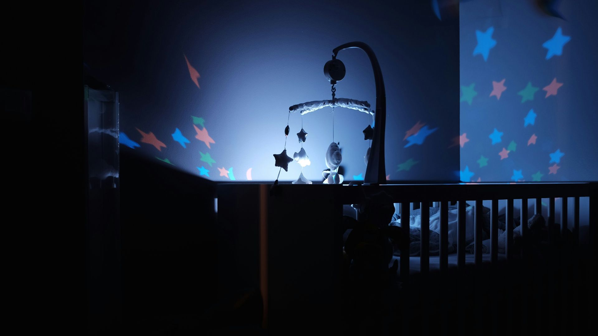 baby's black wooden crib with LED crib mobile