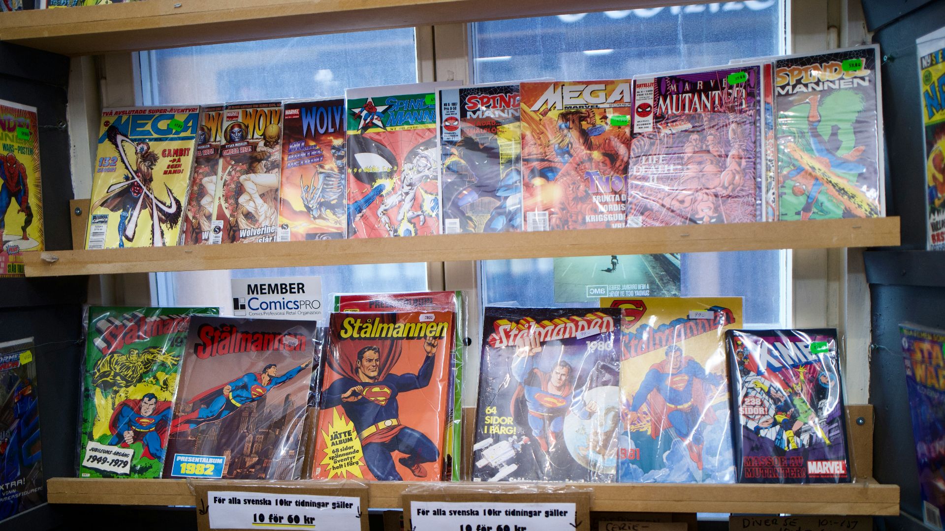 assorted books on brown wooden shelf