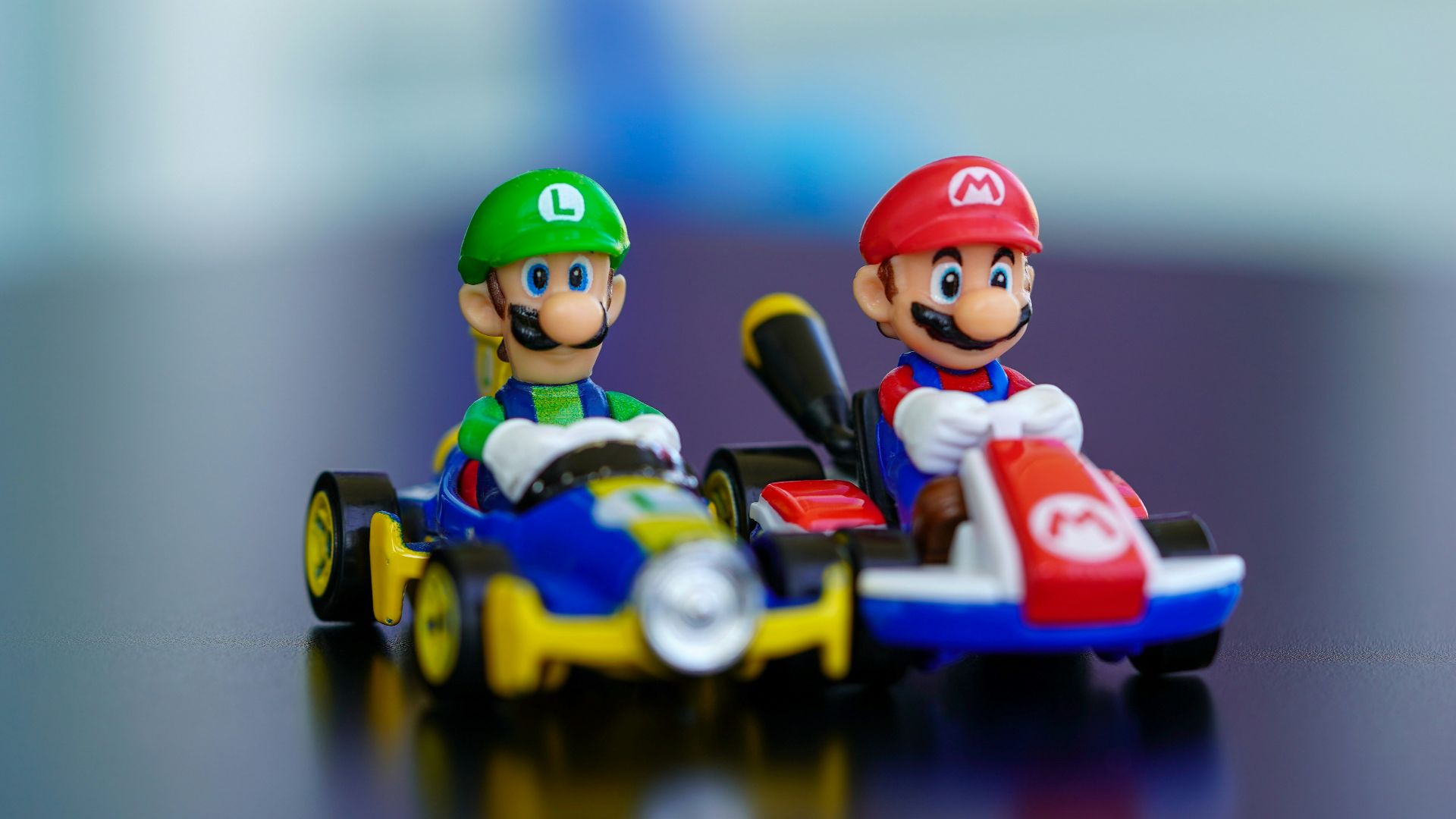 lego mini figure riding blue and red toy car