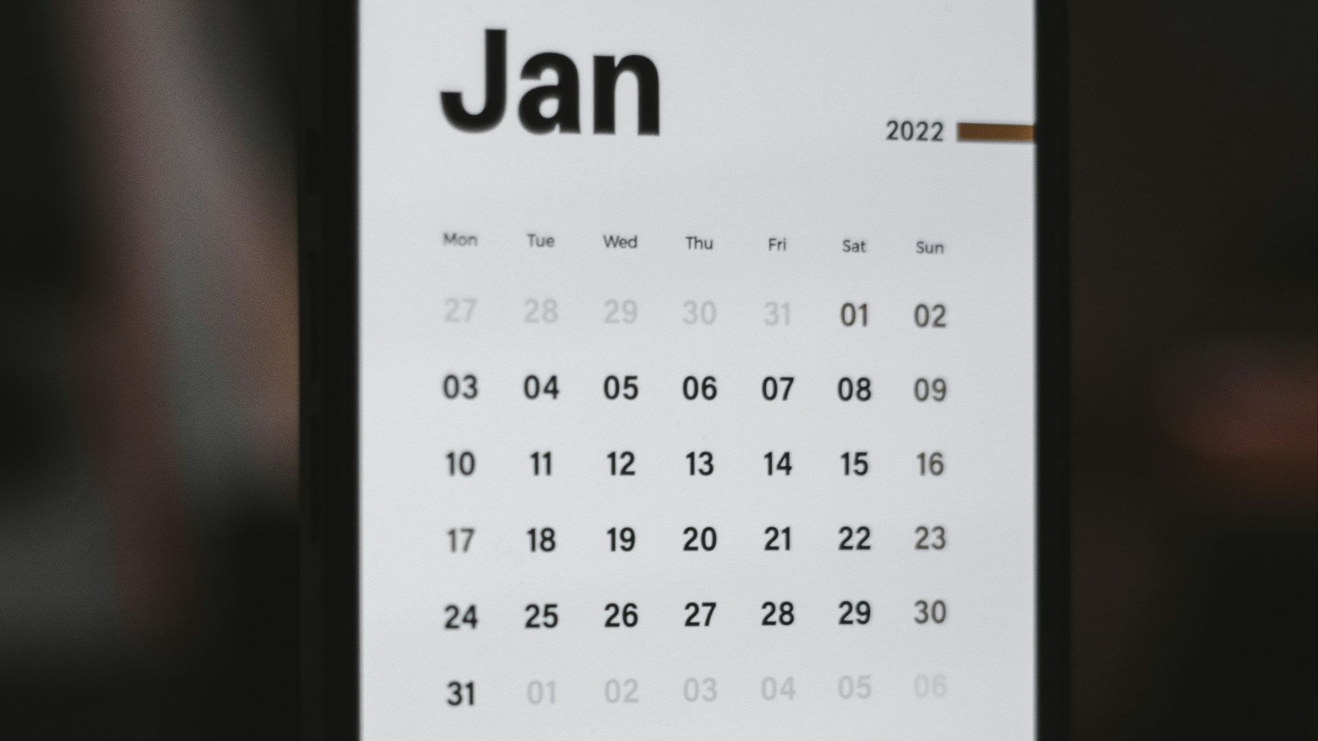 a white and black calendar phone case sitting on top of a table