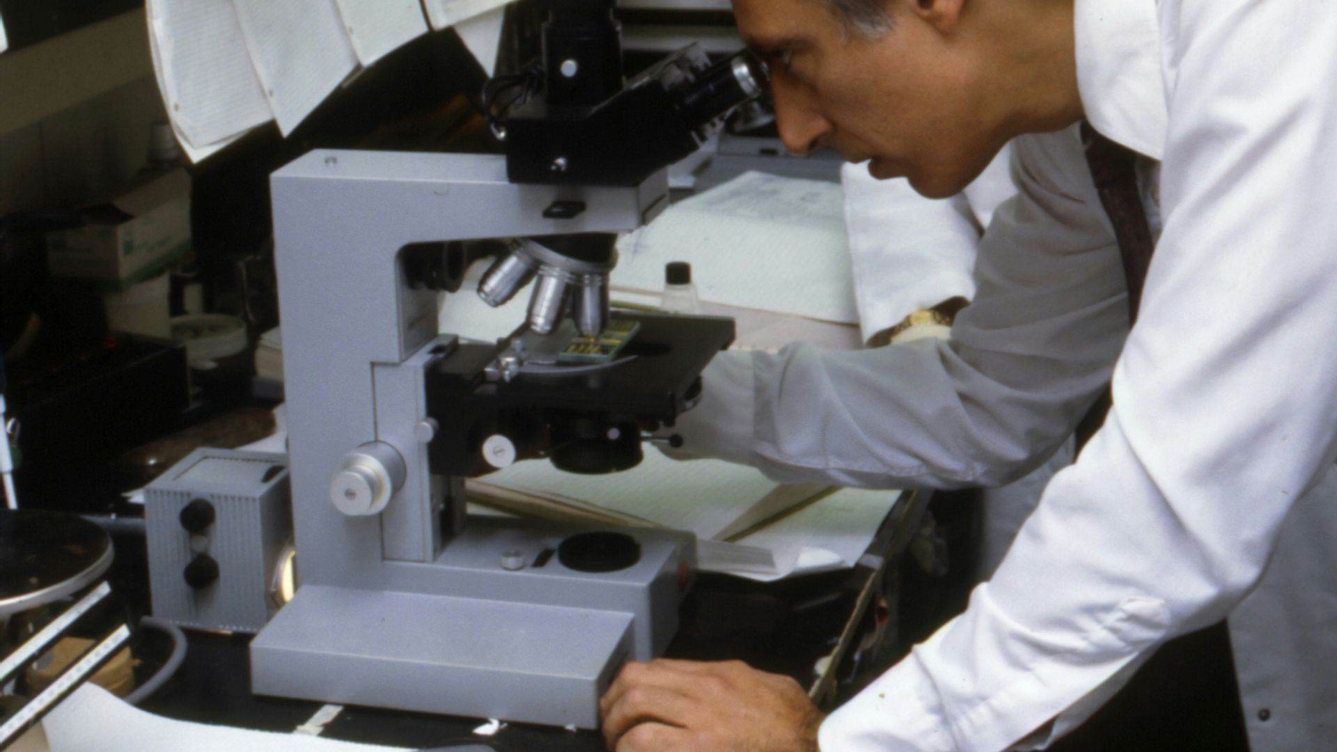 man using microscope