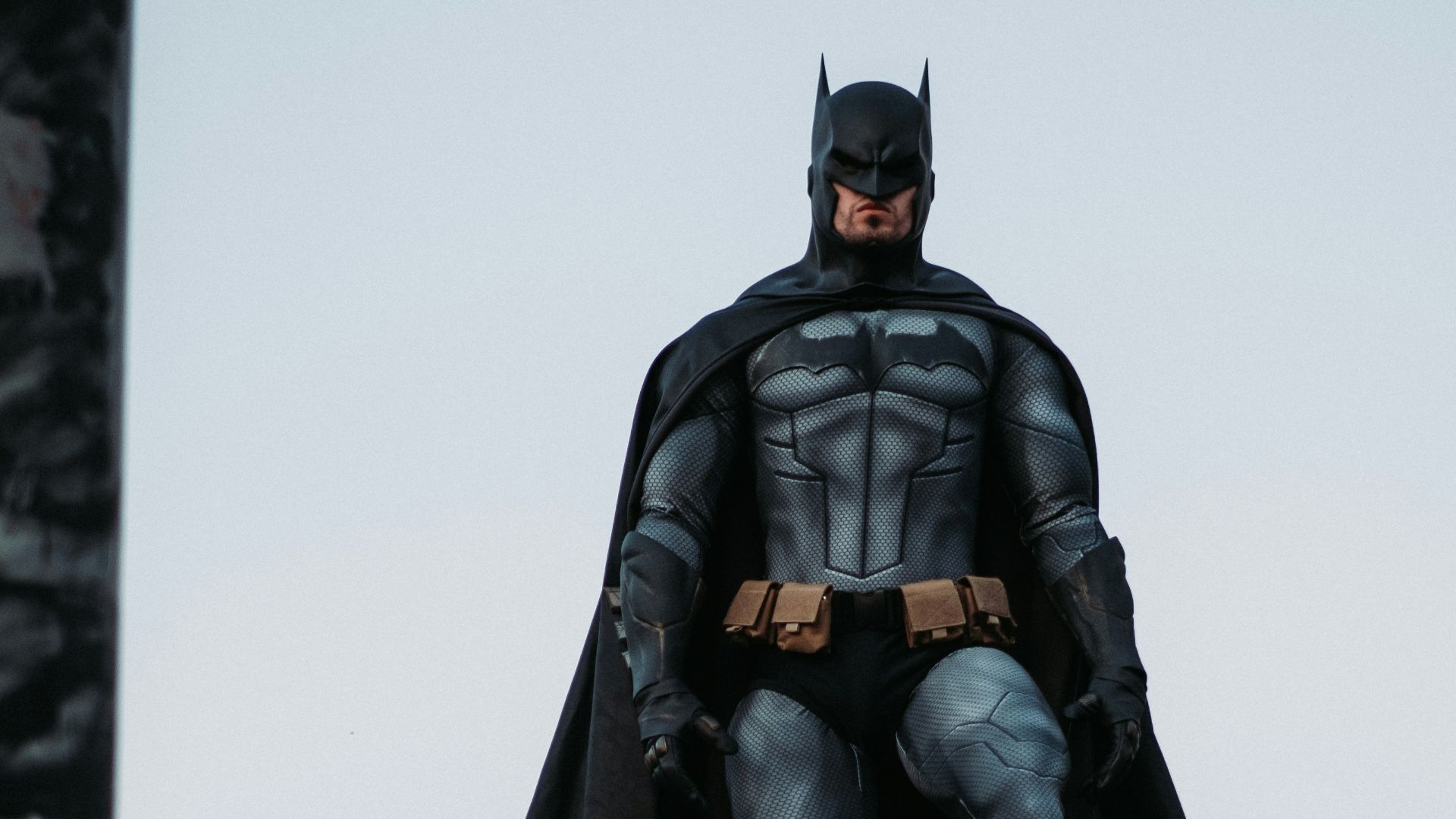 man in black jacket and pants standing on roof