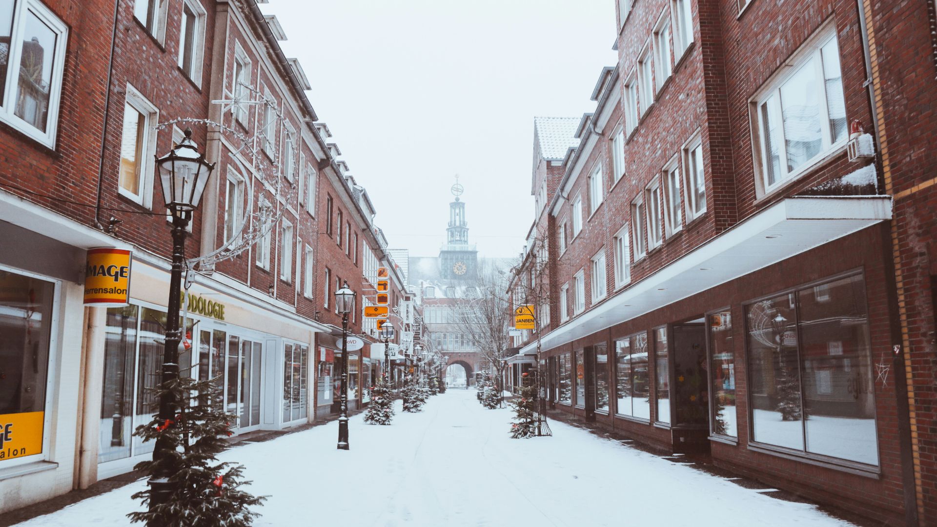 field covered with snow near buildings