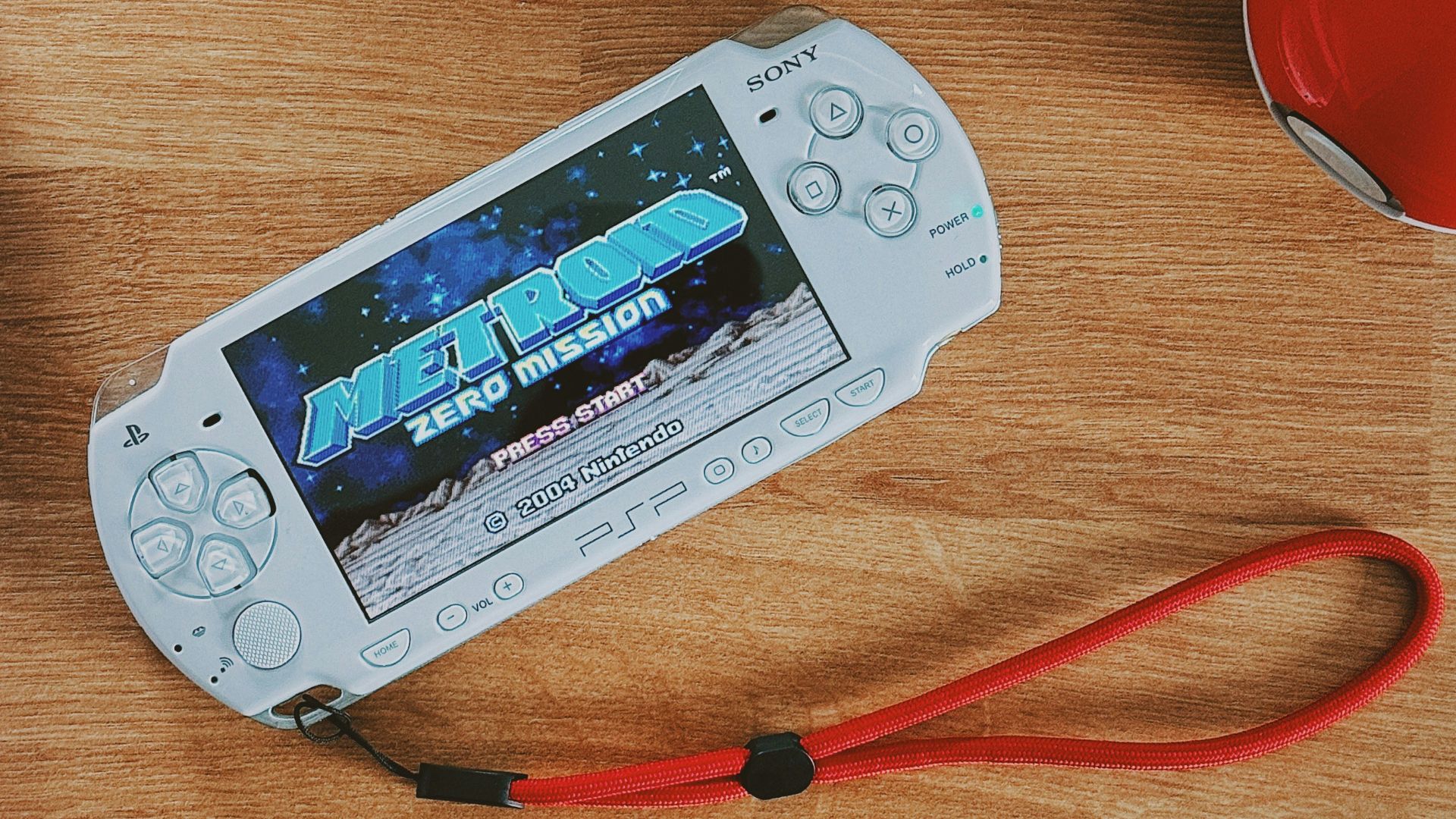 a nintendo wii game system sitting on top of a wooden table