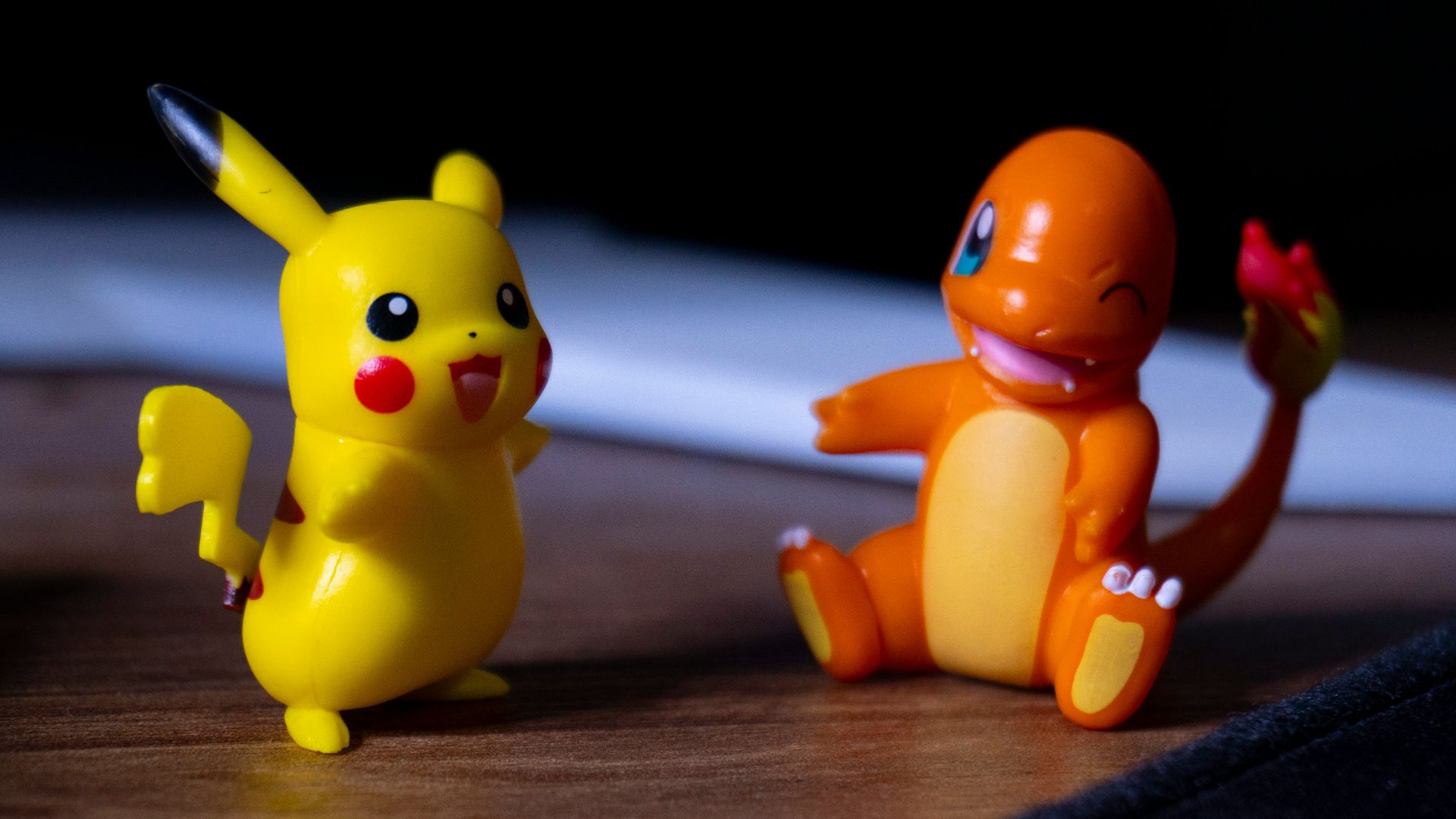 A couple of toy figurines sitting on top of a wooden table