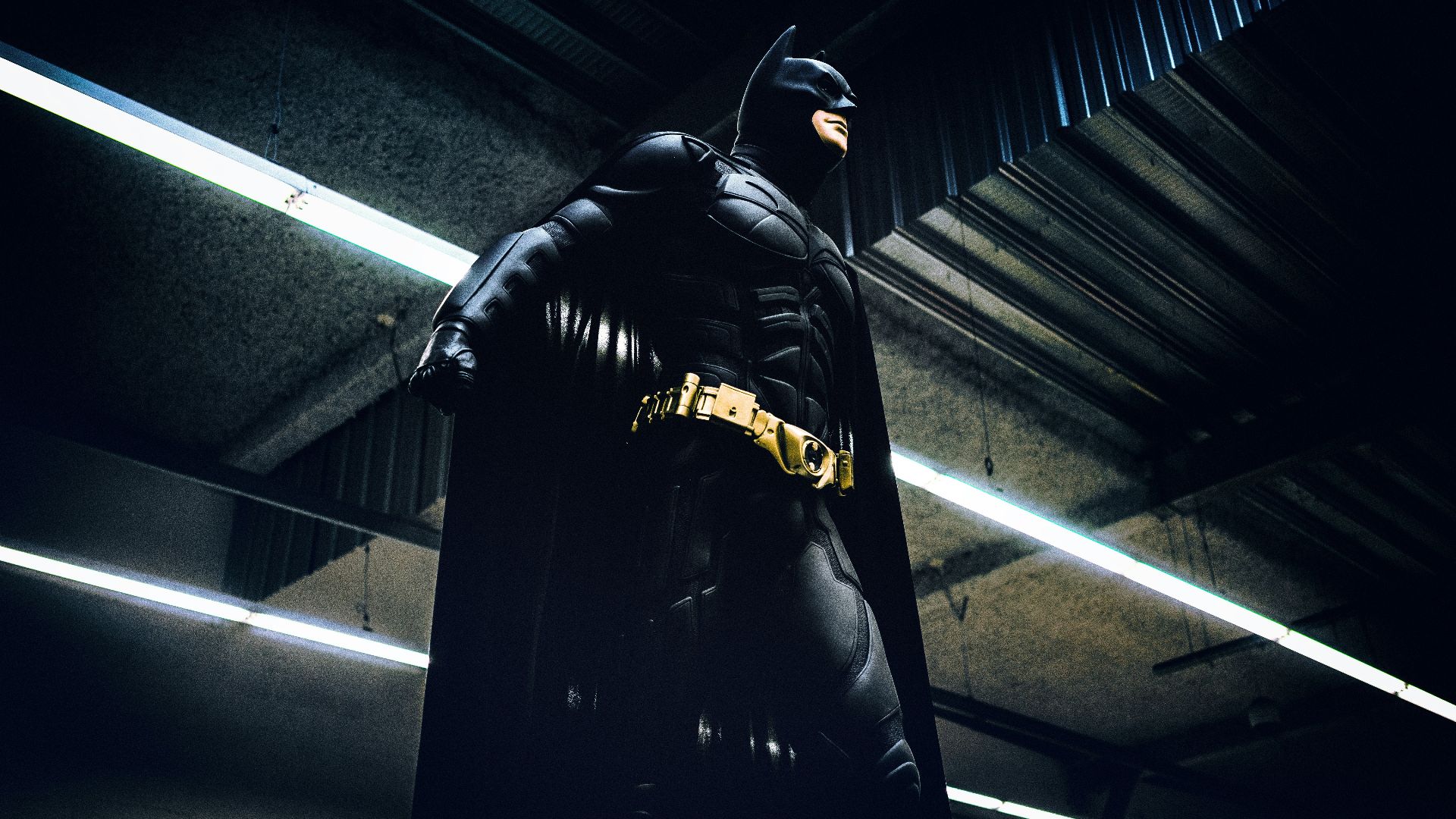 Batman standing under steel roof