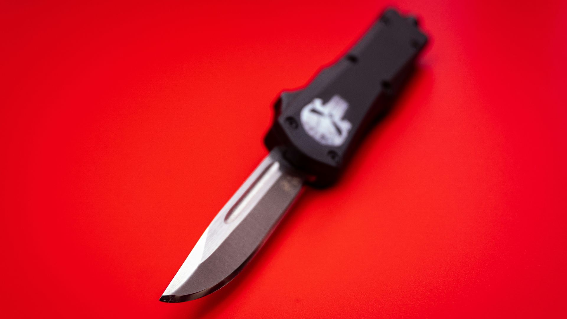 black and silver knife on red surface