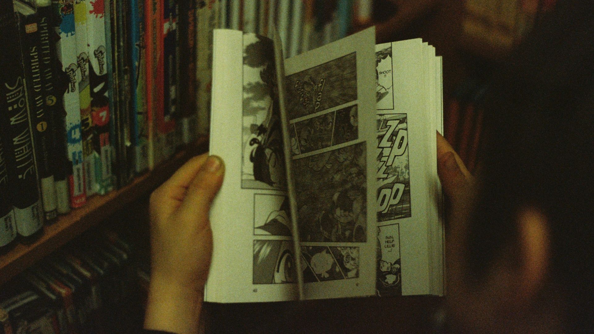 person holding white and black book