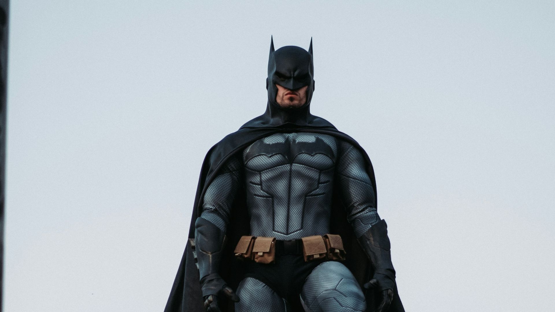 man in black jacket and pants standing on roof