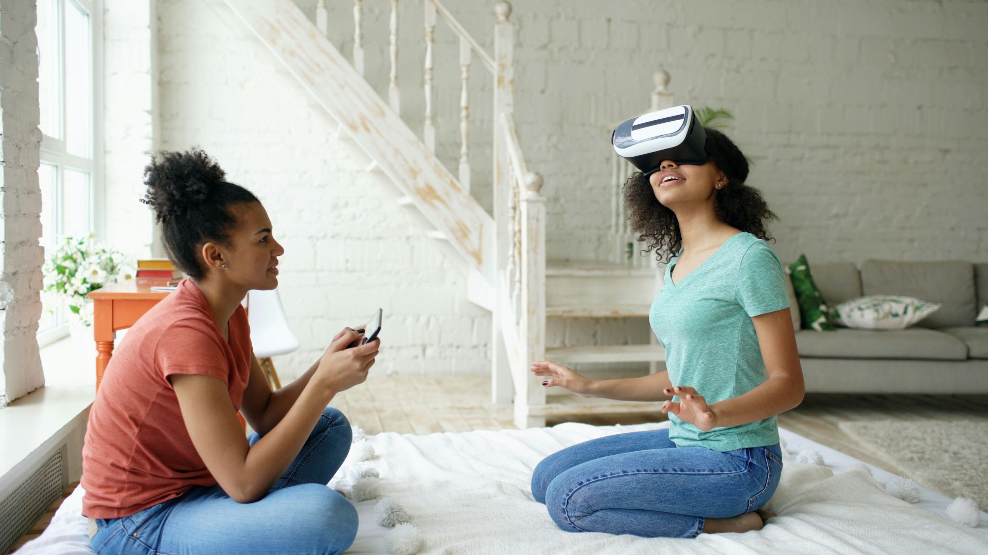 Two young women experiencing virtual reality together