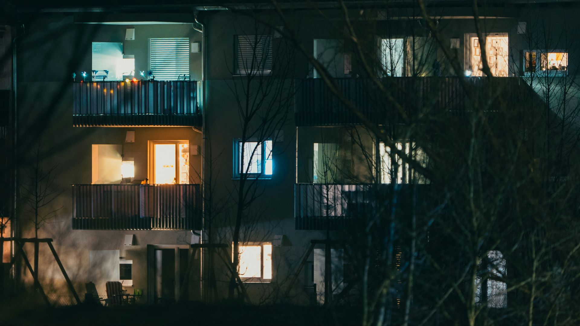 A tall building with windows lit up at night