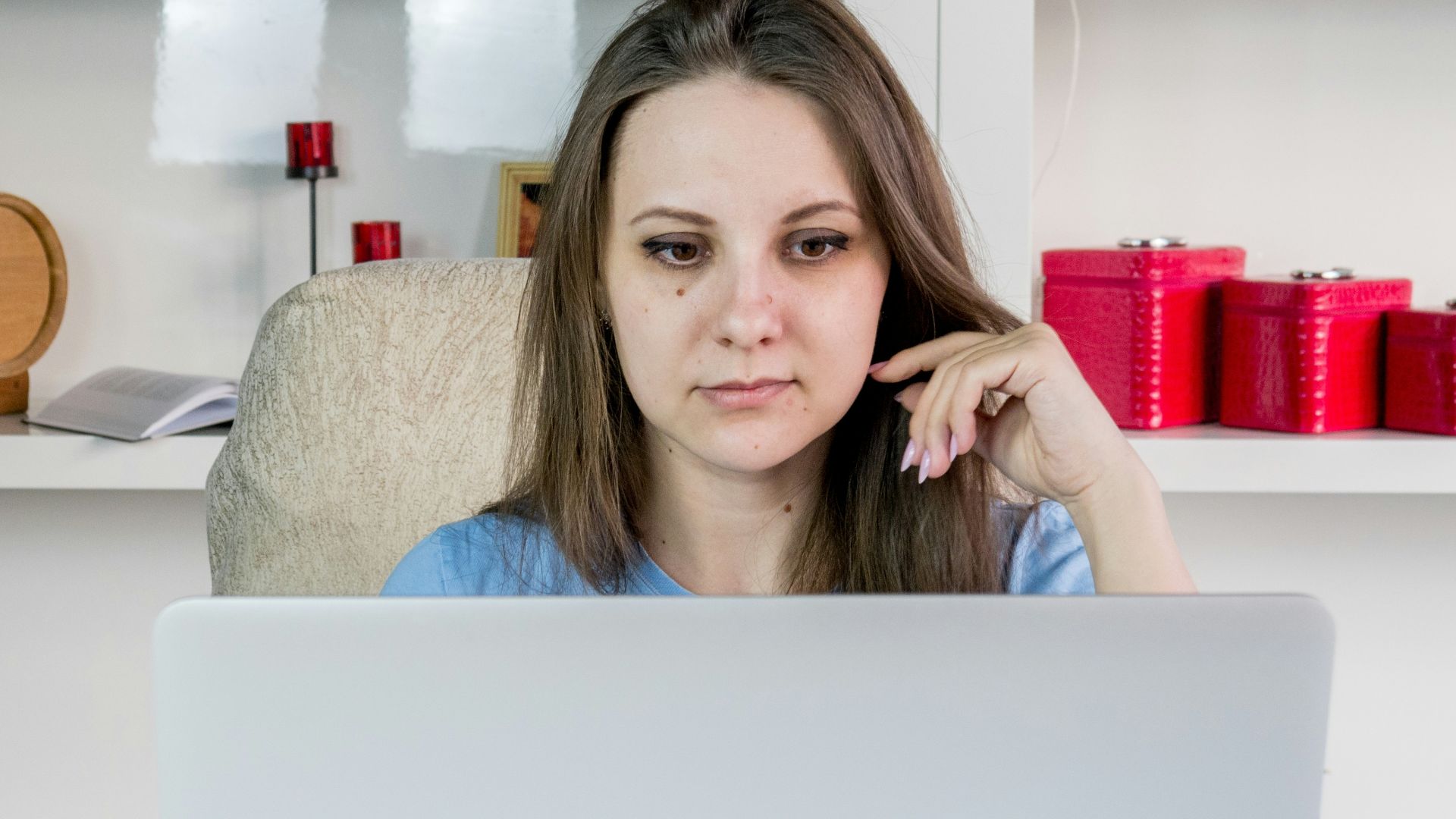 a woman sitting in front of a laptop computer