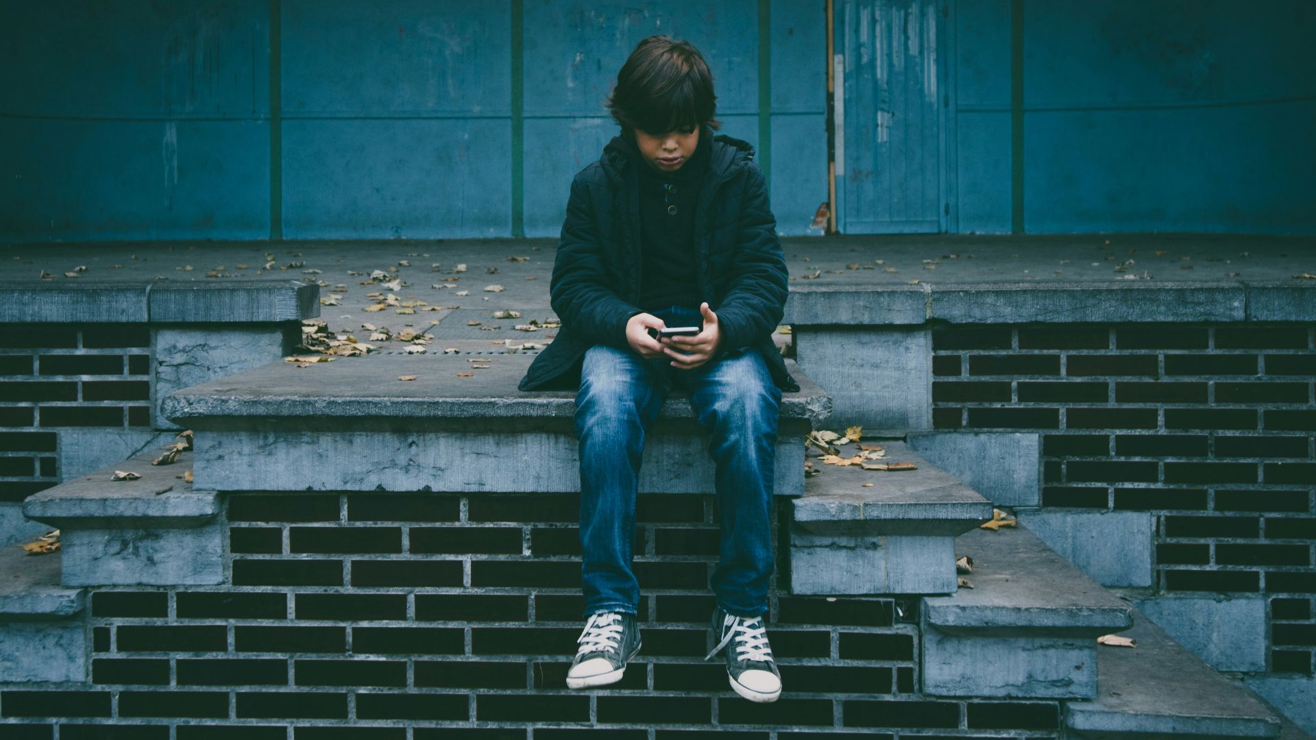 boy sitting on concrete stairs