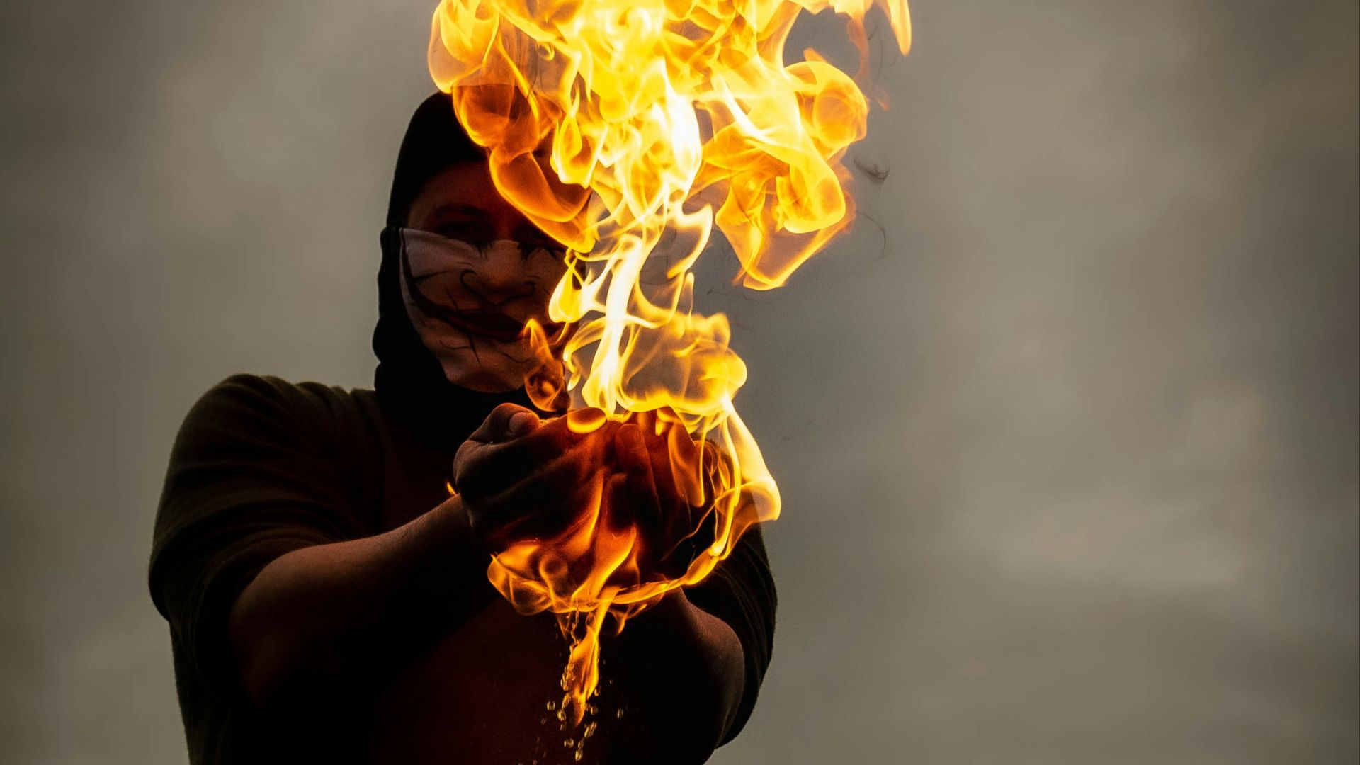 a man holding a fire stick in front of his face