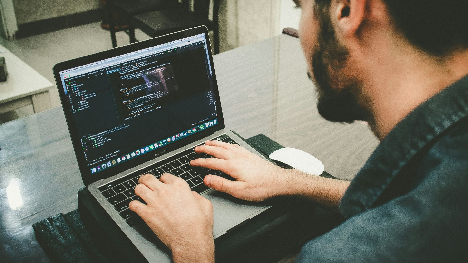 man programming using laptop