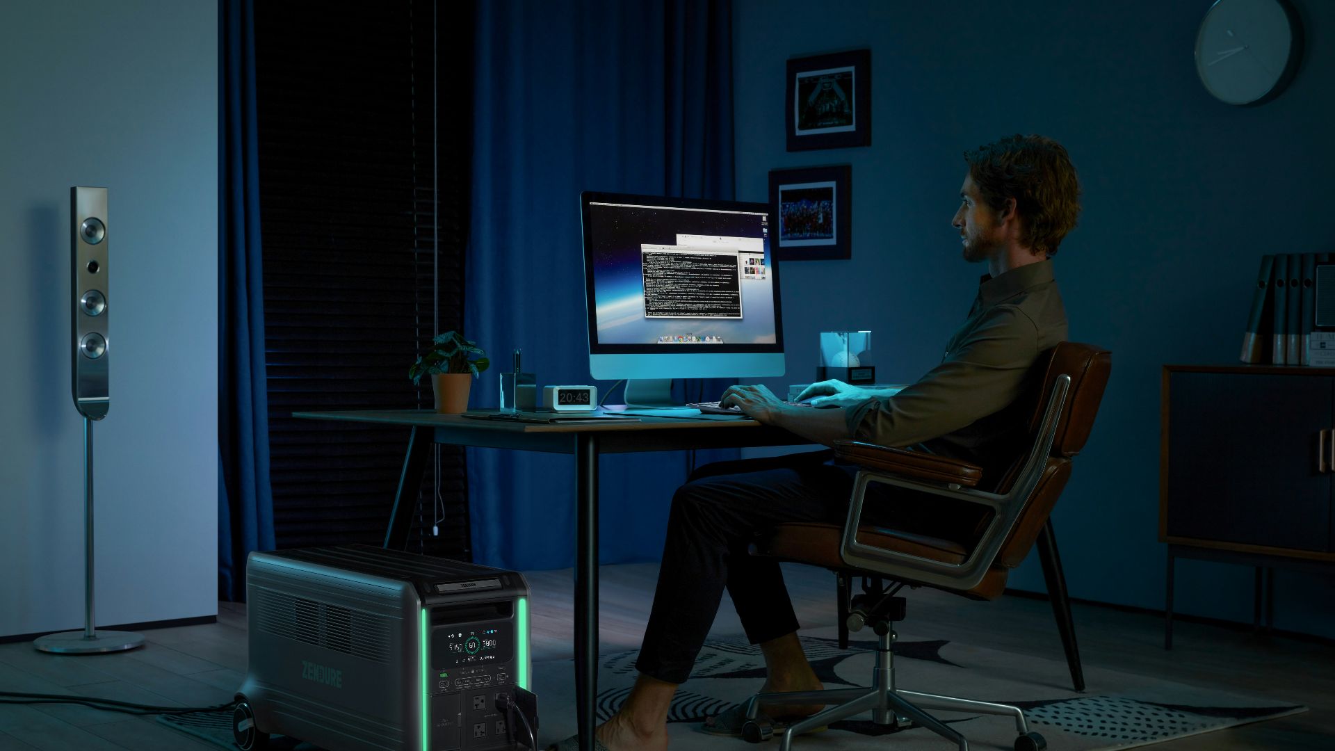 a man sitting at a desk in front of a computer