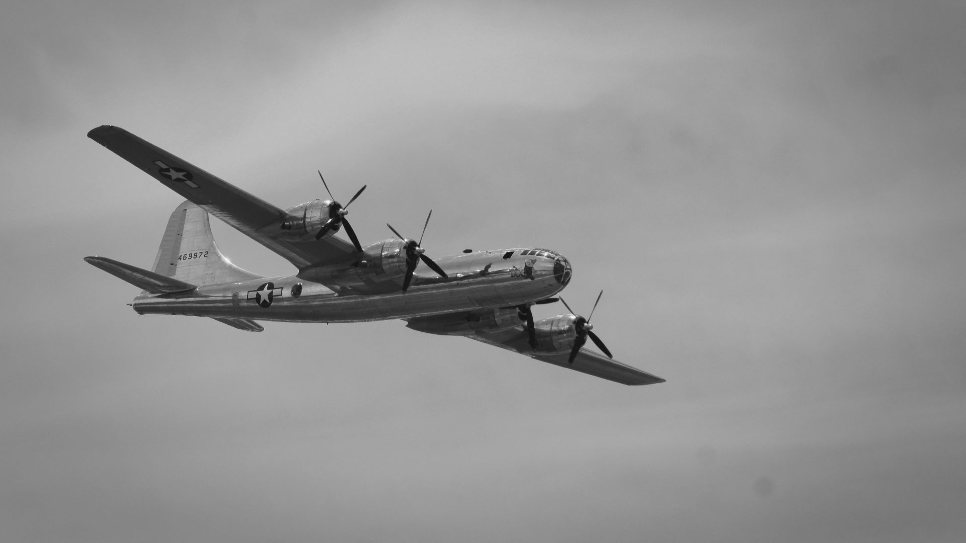 grayscale photography of flying plane
