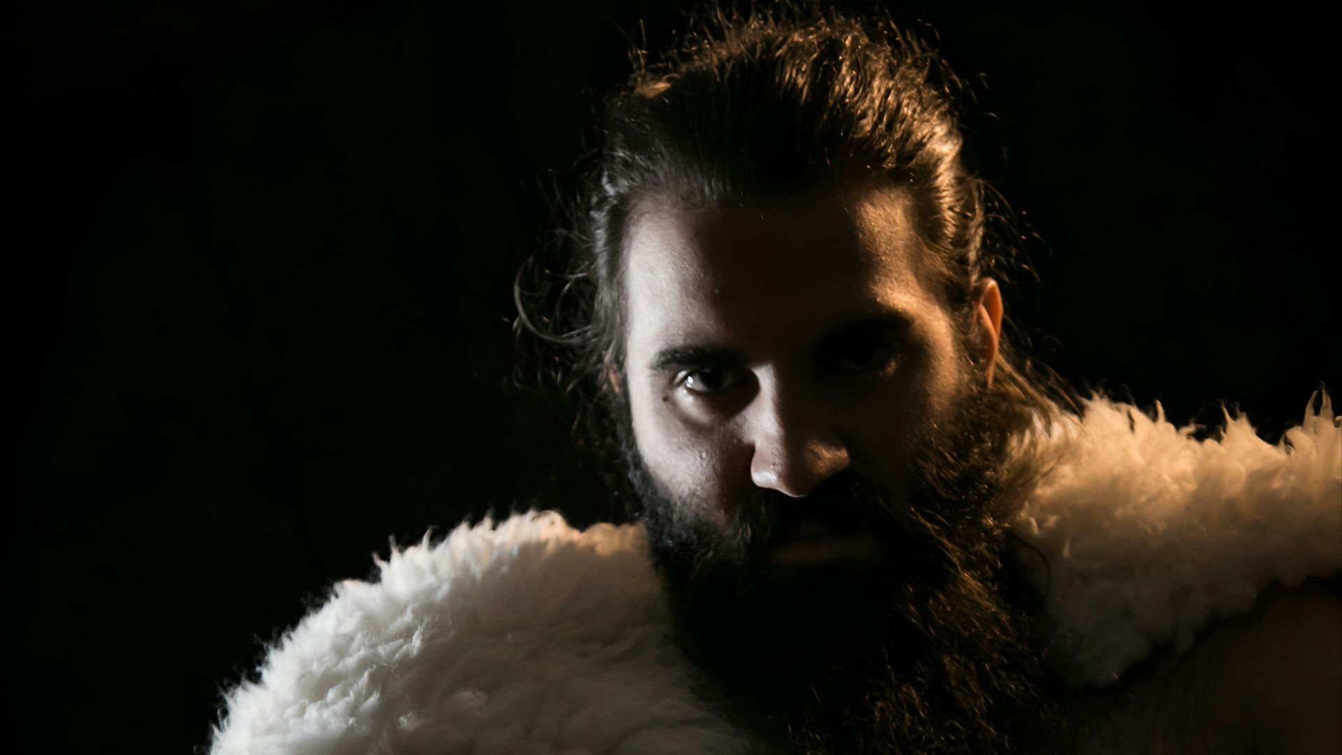 a man with a sword and a beard