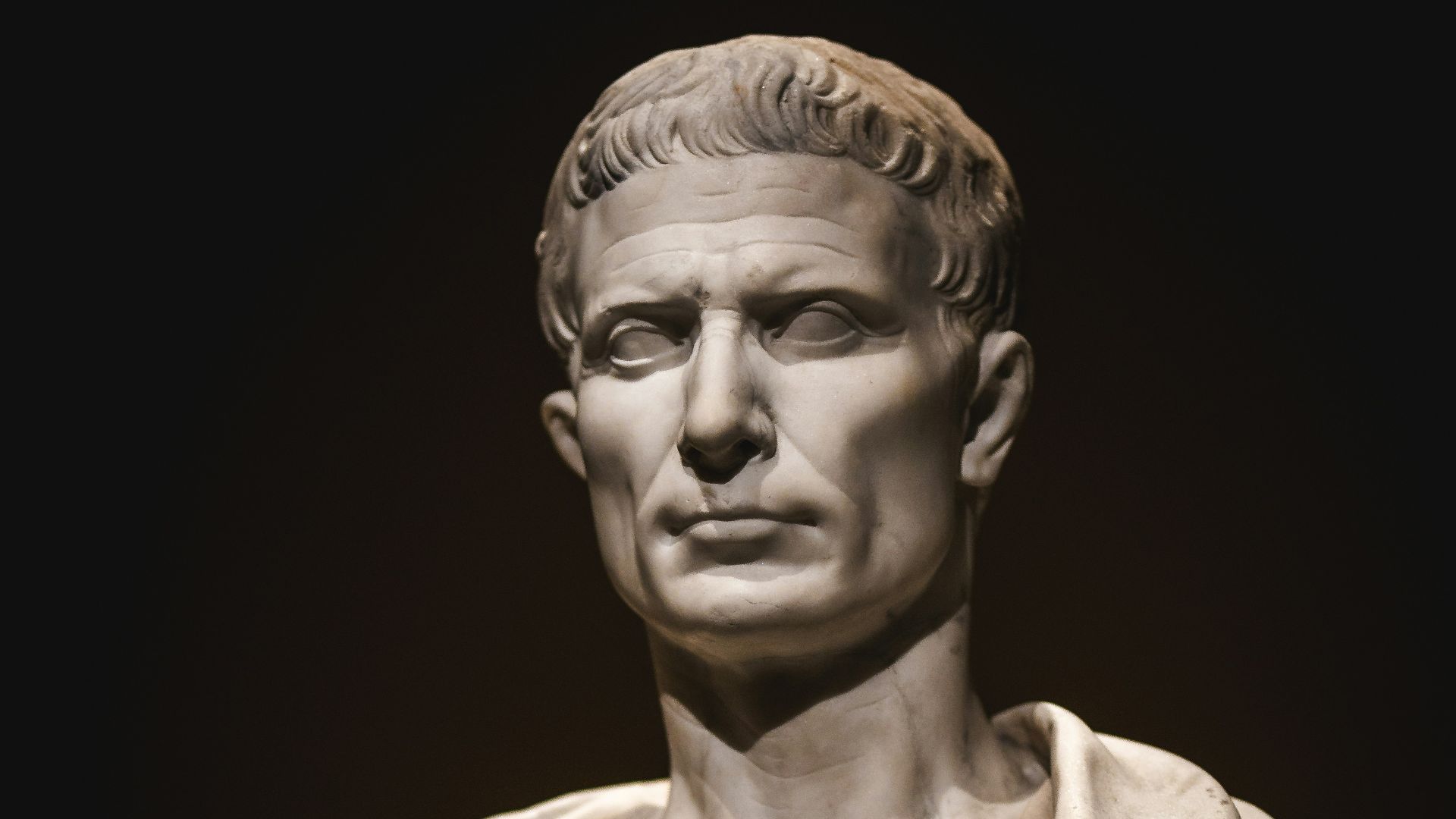 A bust of a man with a cape around his neck