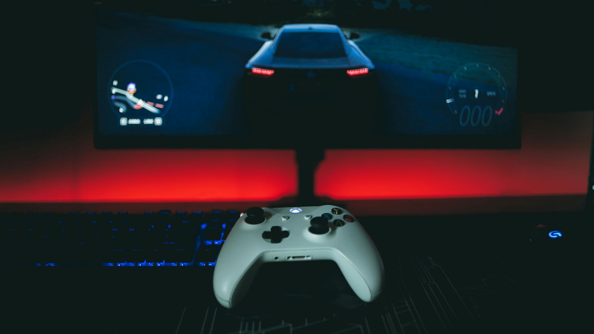 a video game controller sitting in front of a monitor