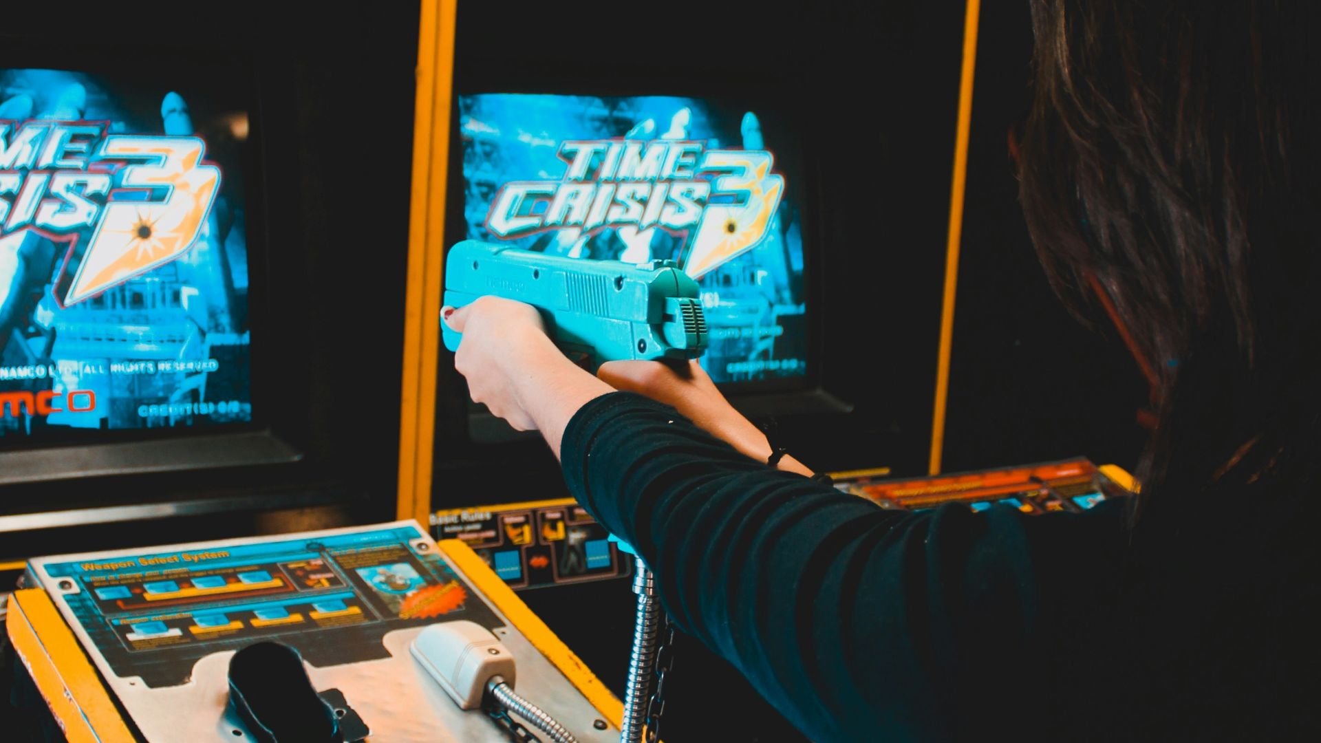woman playing arcade machine