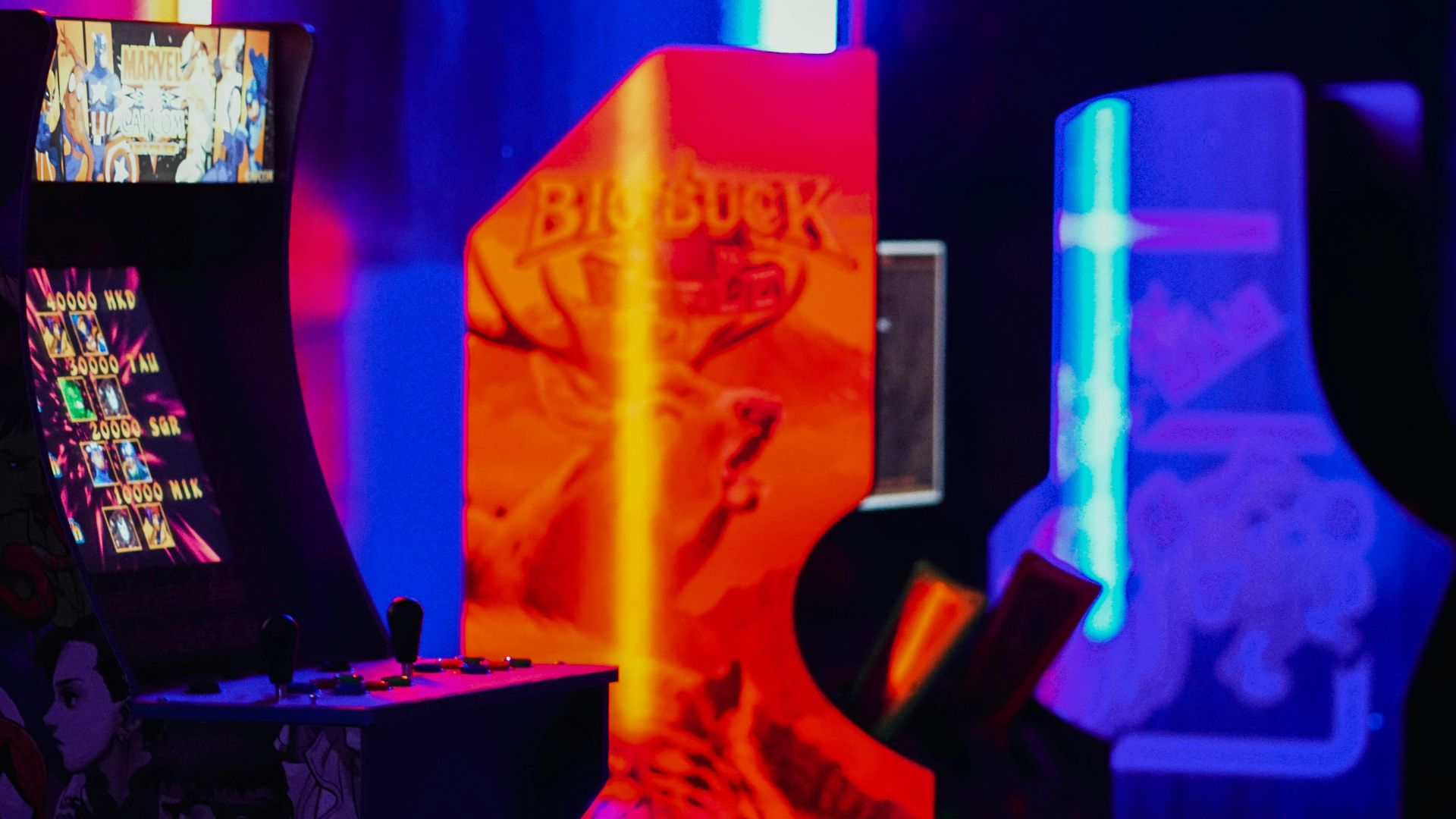 a video game machine with neon lights in the background