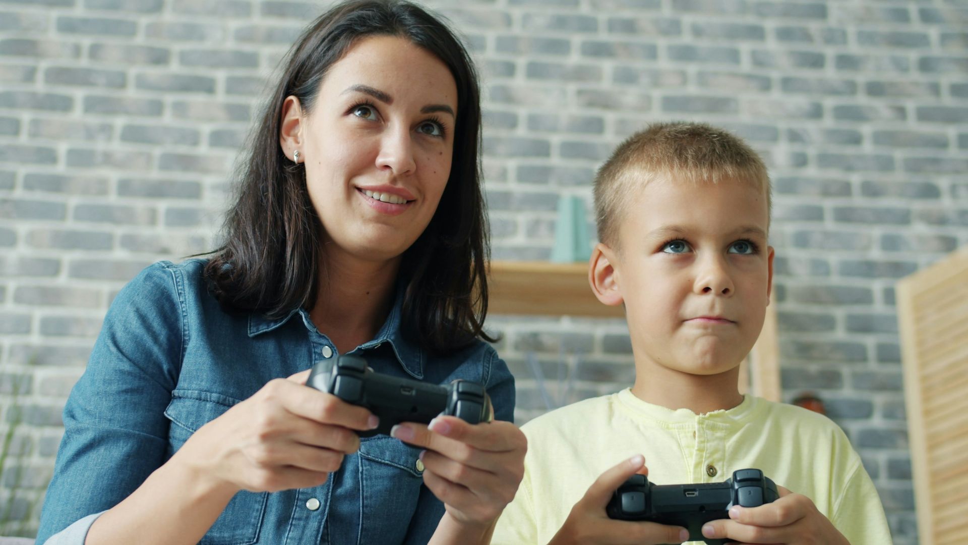 Mother and son playing video games together