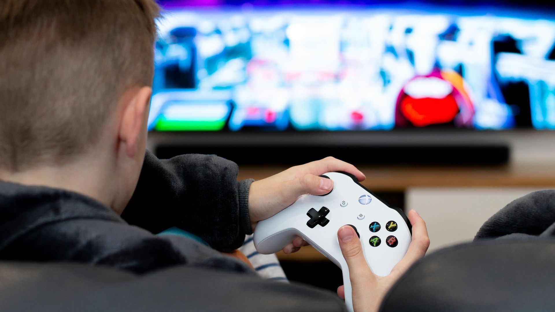 a young boy playing a video game on the nintendo wii