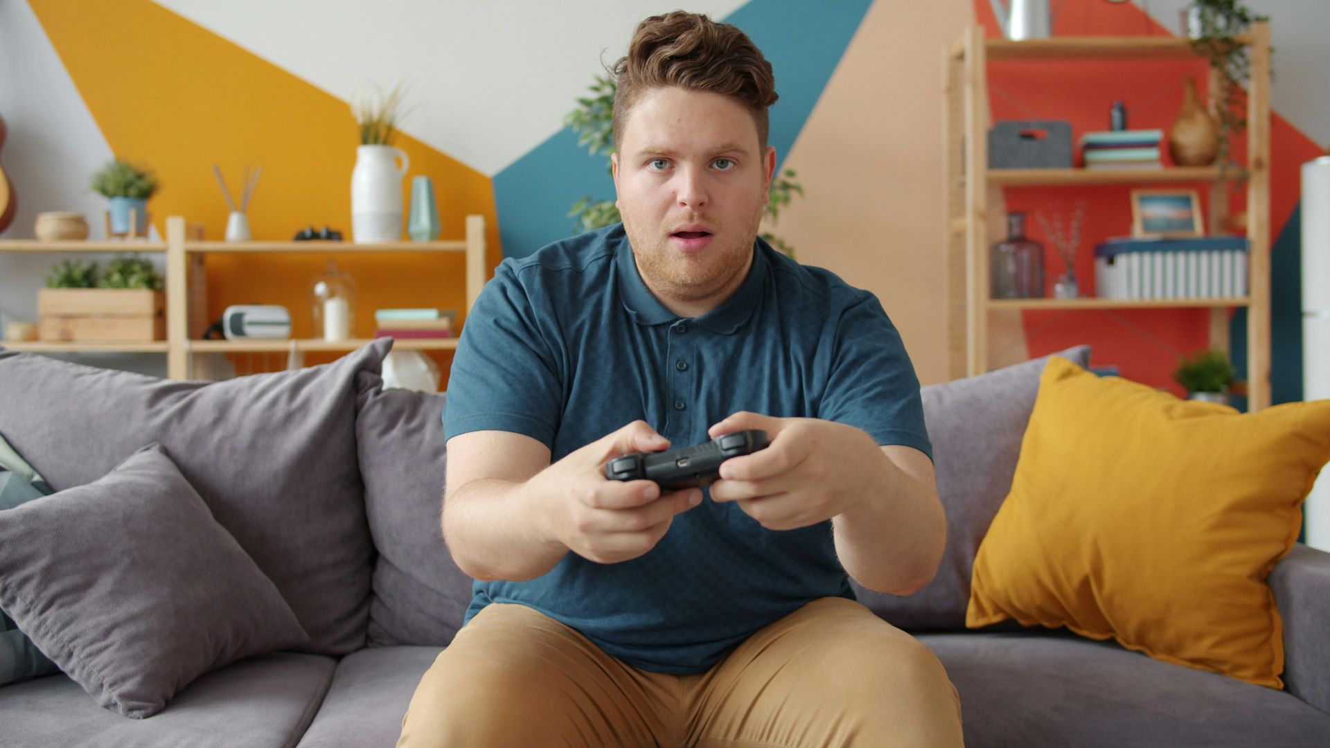Man playing video games on a couch