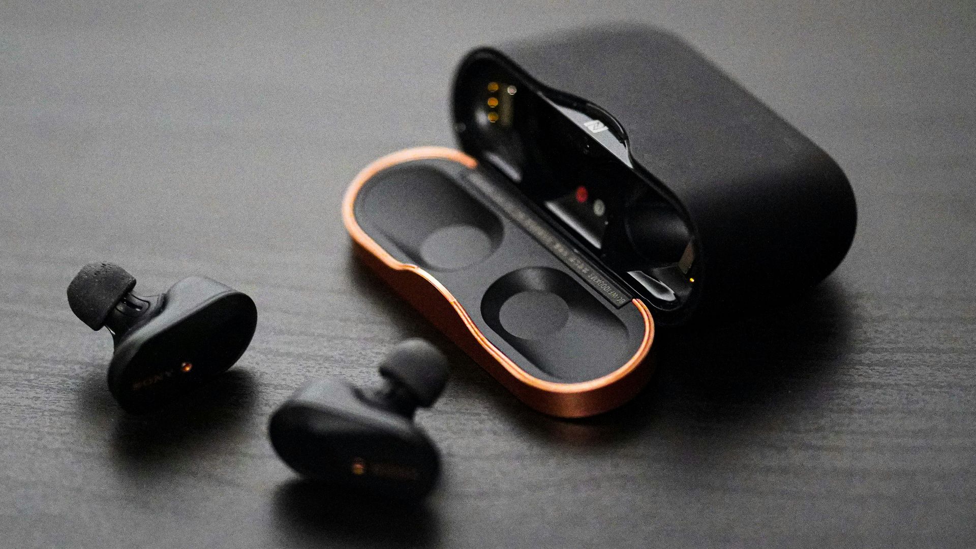 black wireless earphones on surfae