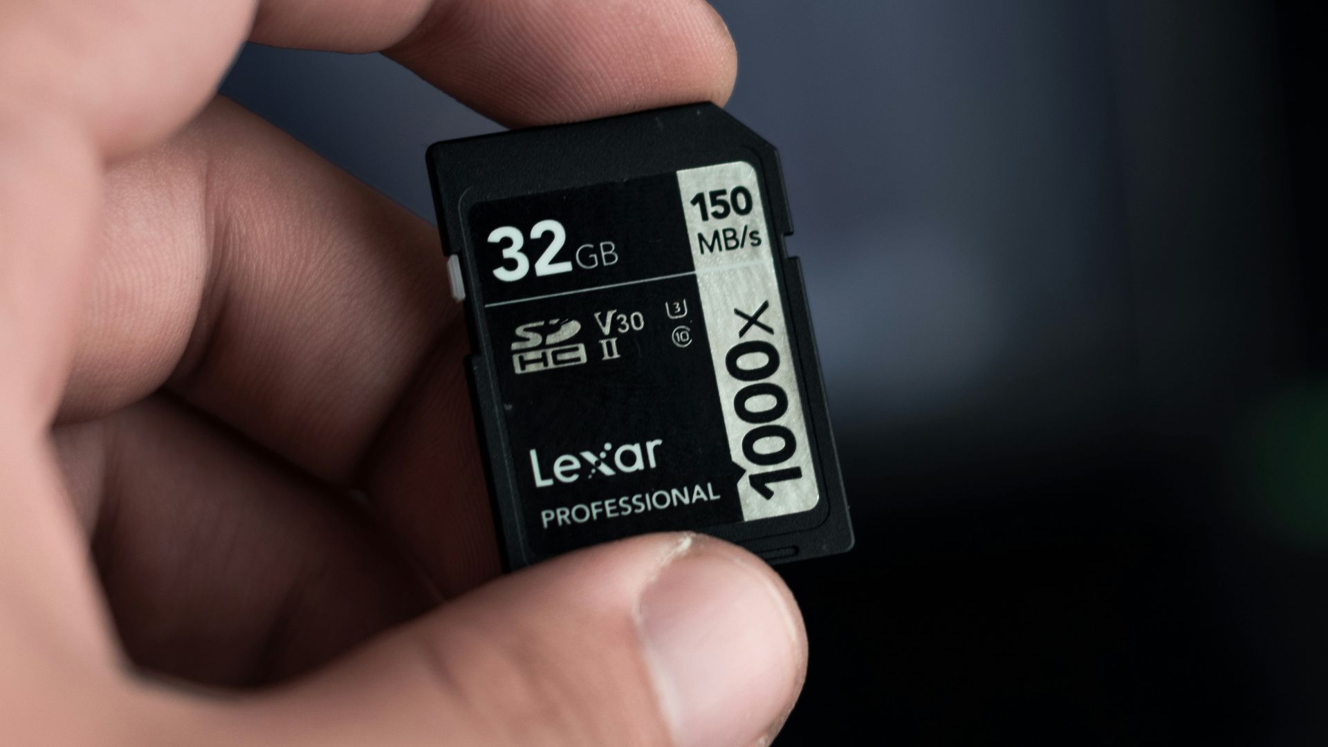 a hand holding a micro sd memory card