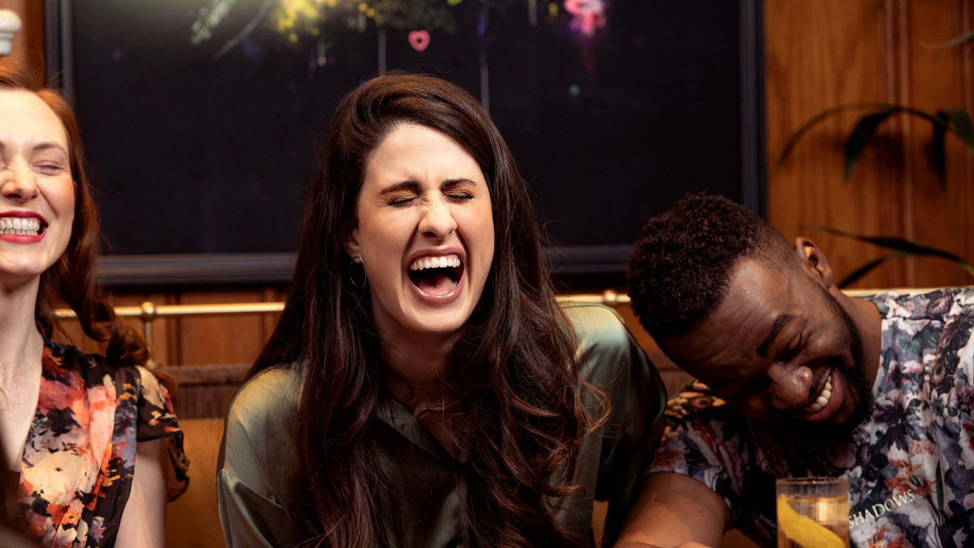 a group of people sitting around a table with drinks