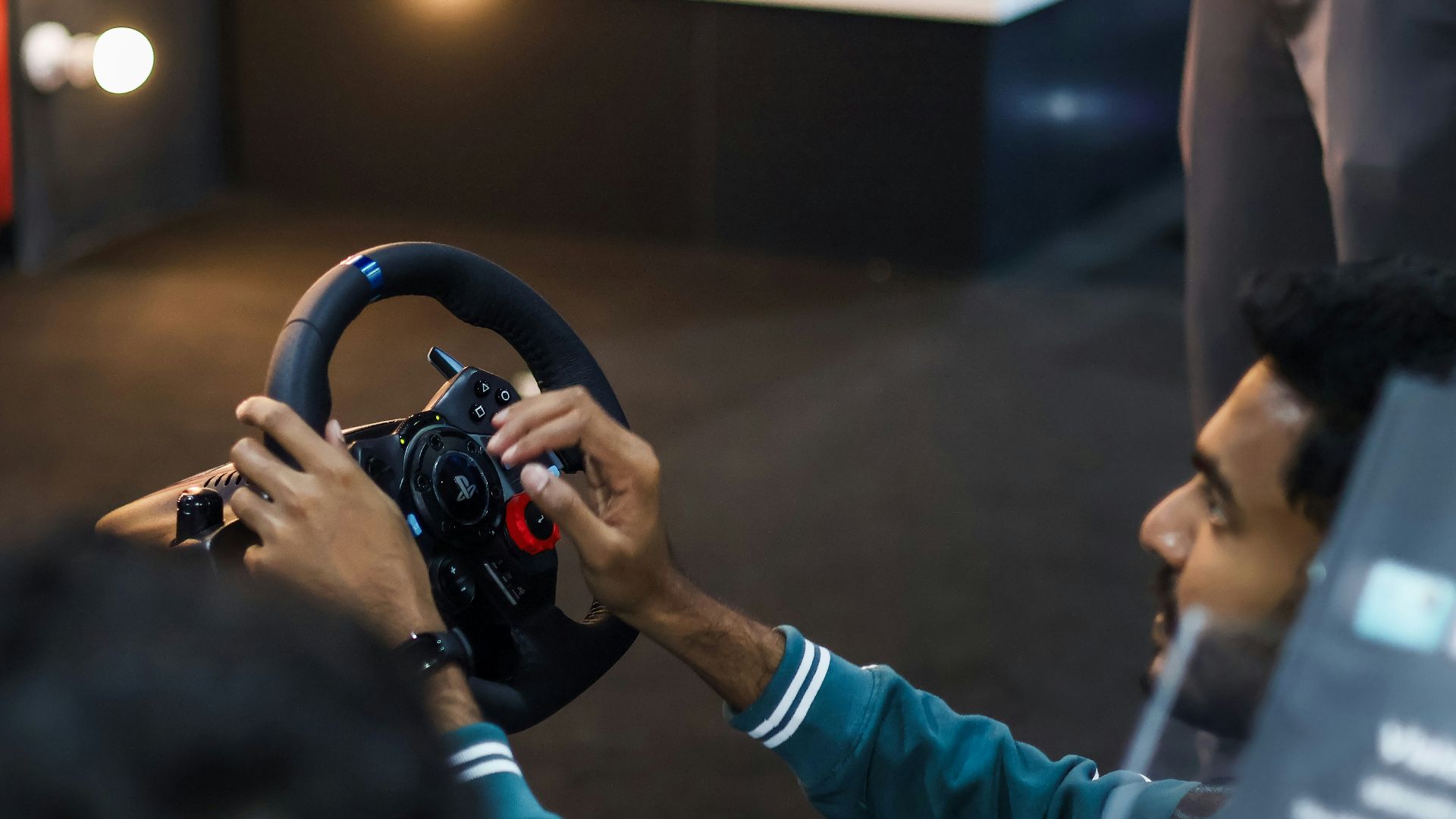 Man playing racing simulator with steering wheel