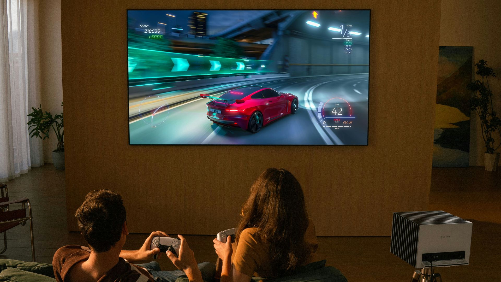 Two people playing a racing video game on television