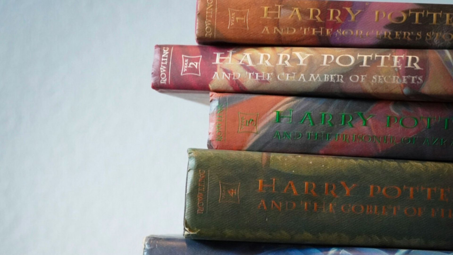a stack of books sitting on top of a wooden table