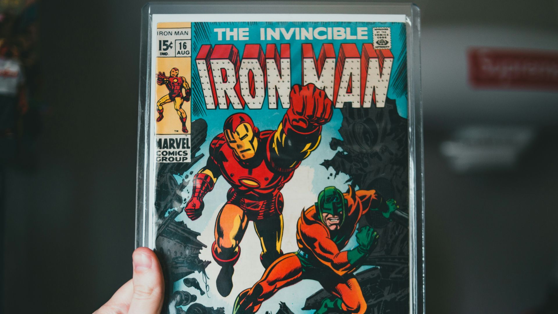 a person holding a comic book in their hand