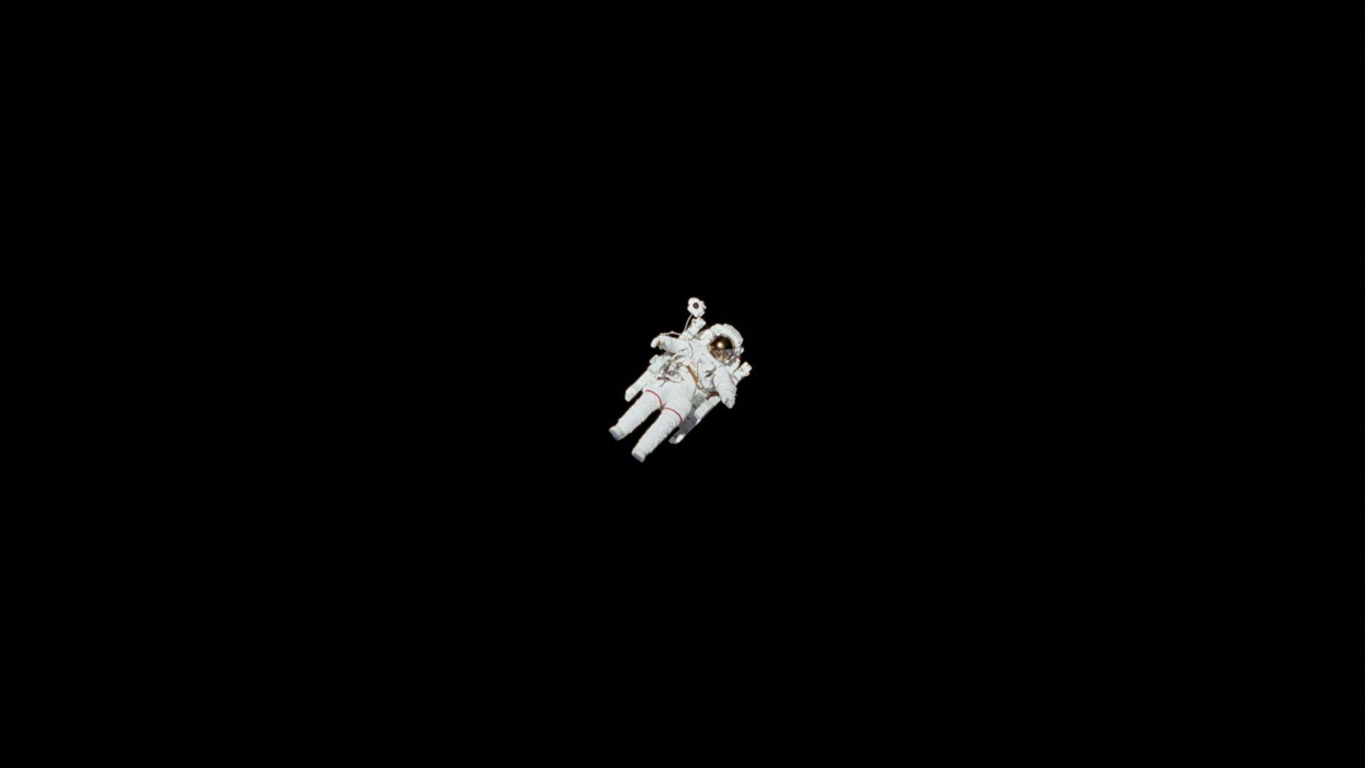 astronaut in spacesuit floating in space