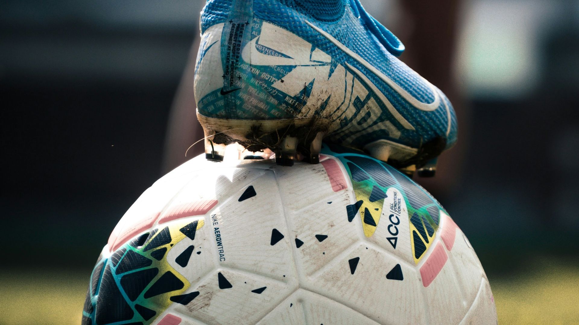 white and blue soccer ball on green grass field